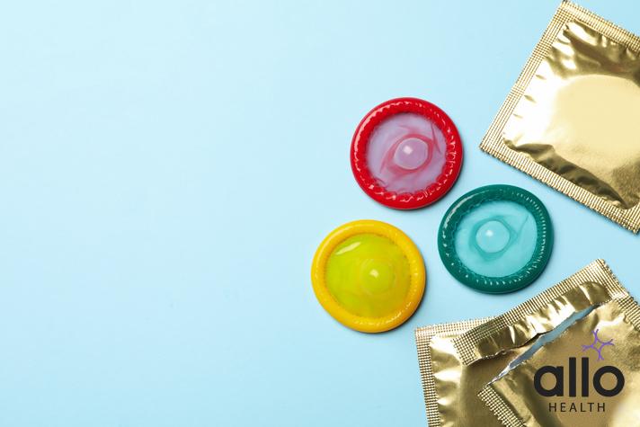 how to dispose of condoms, Multicolored condoms on blue background, space for textCondom Broke Pregnancy Risk Emergency Contraception
